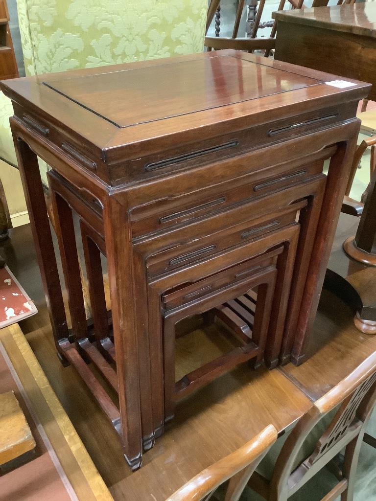 A Chinese nest of hardwood quartetto tables, largest 50cm